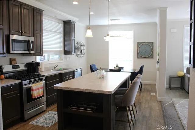 a kitchen with a table chairs sink and stove