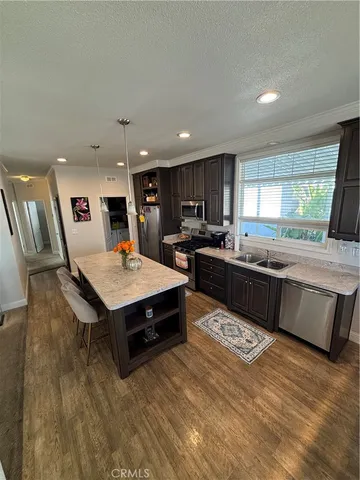 a kitchen with a stove sink and a refrigerator