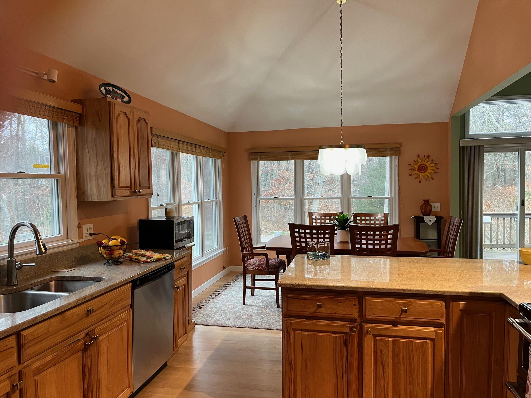 45 John Myrick Circle Brewster, MA 02631 - Photo 13 of 32 a kitchen with sink a large window and chairs