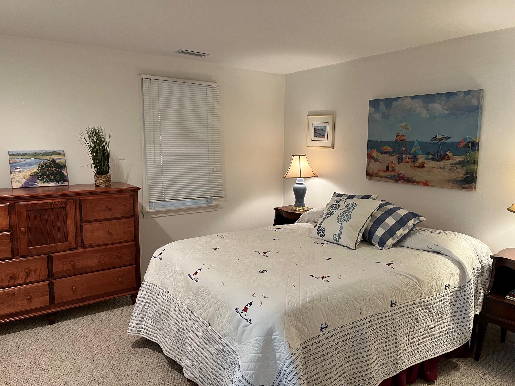 45 John Myrick Circle Brewster, MA 02631 - Photo 27 of 32 a bedroom with a bed and a painting on the wall