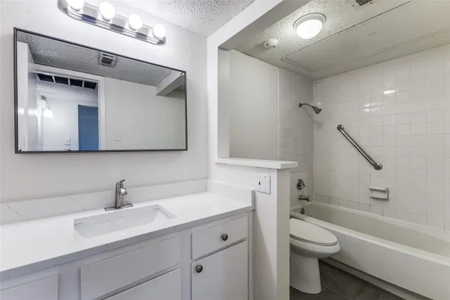a bathroom with a toilet a sink a mirror and bathtub