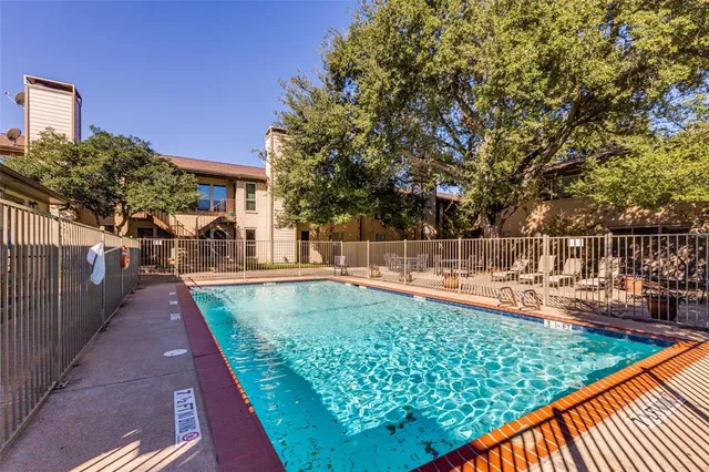 a view of a swimming pool with a patio