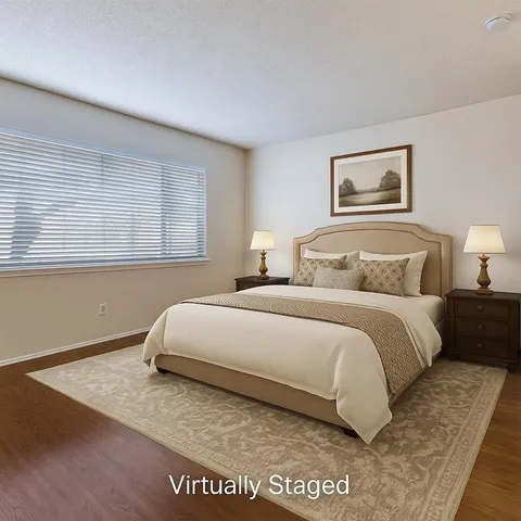 a bedroom with a bed and a painting on the wall