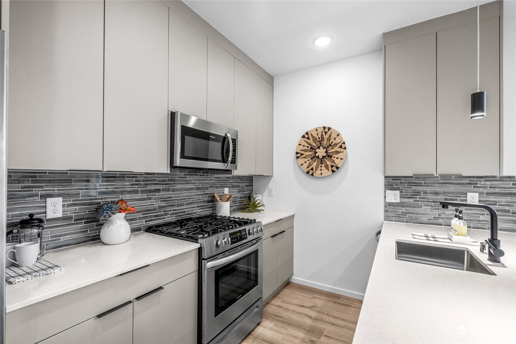 1621 South State Street Seattle, WA 98144 - Photo 11 of 23 a kitchen with stainless steel appliances a stove a sink and a microwave