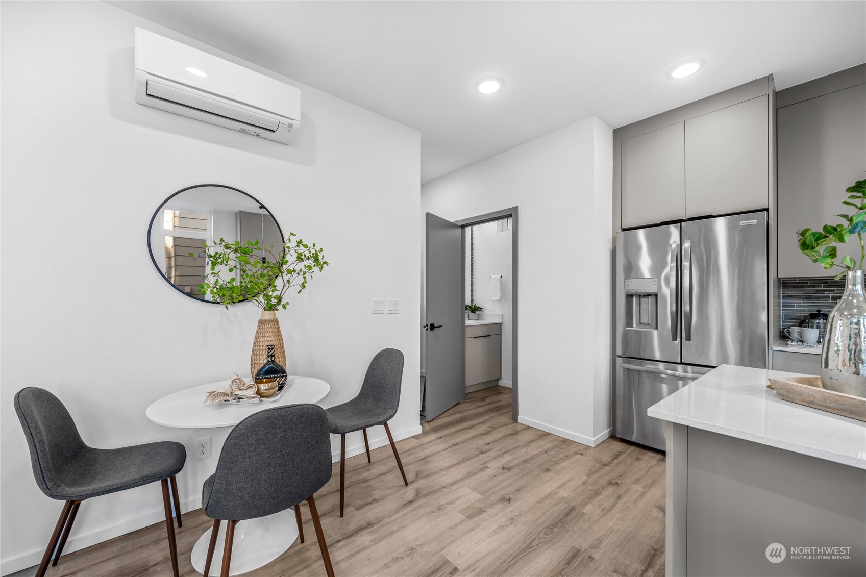 1621 South State Street Seattle, WA 98144 - Photo 12 of 23 a kitchen with stainless steel appliances granite countertop a stove a refrigerator a microwave a dining table and chairs with wooden floor