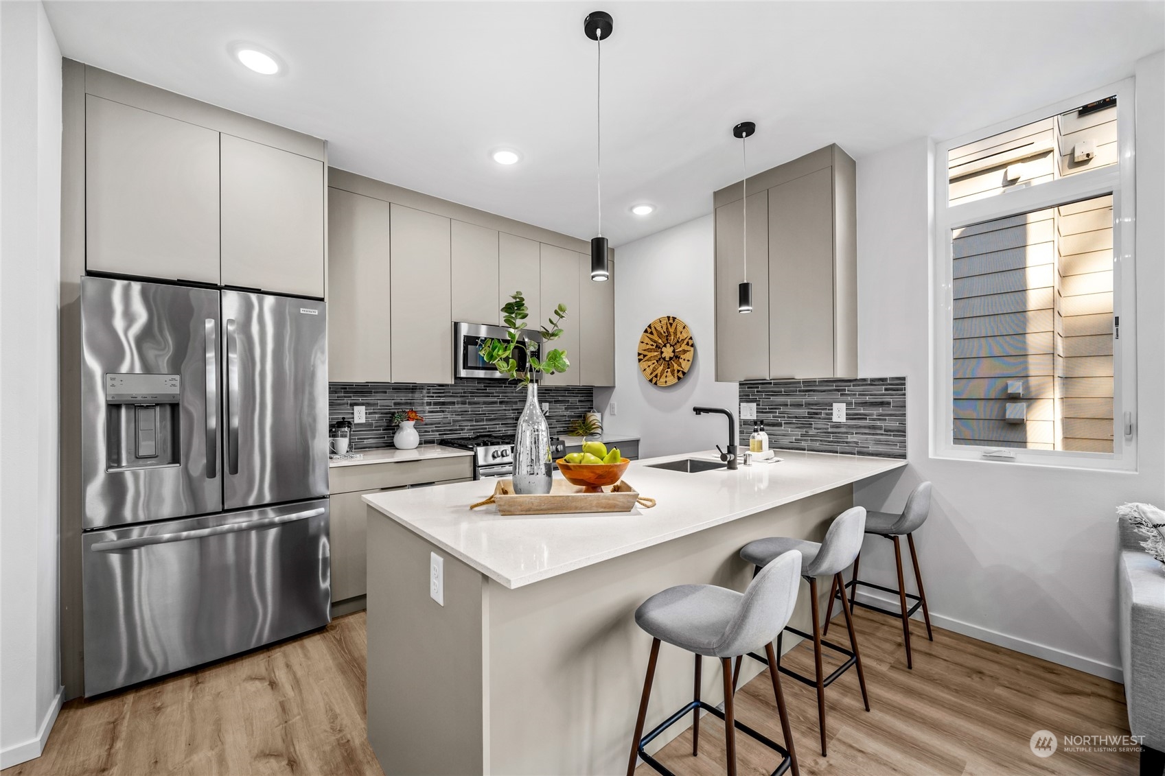 1621 South State Street Seattle, WA 98144 - Photo 6 of 23 a kitchen with stainless steel appliances a refrigerator a sink a stove a dining table and chairs