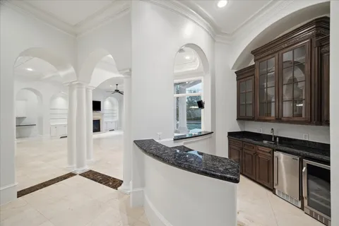 a kitchen with granite countertop a sink and a stove top oven