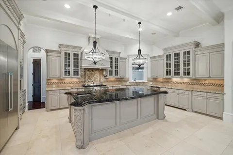 a kitchen with stainless steel appliances granite countertop a stove a sink and a refrigerator