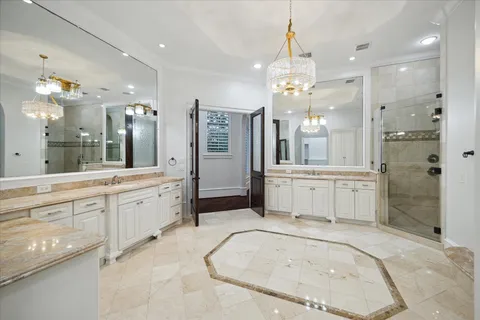 a large bathroom with a granite countertop sink a large mirror and shower
