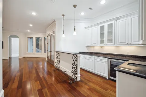 a kitchen with granite countertop a stove and a wooden floors