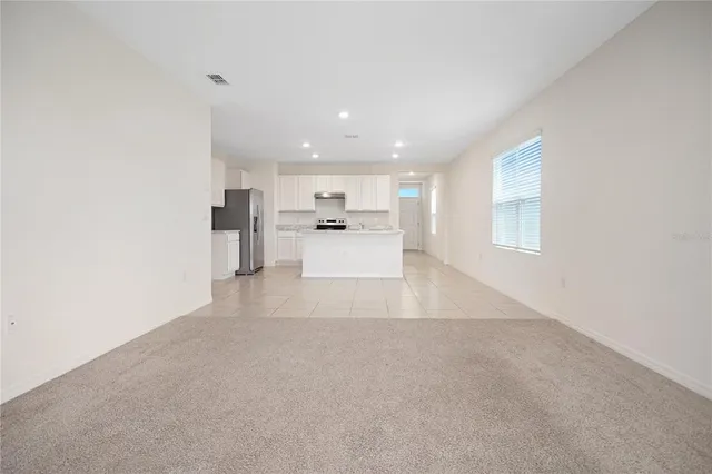 a view of a kitchen with a sink and cabinets
