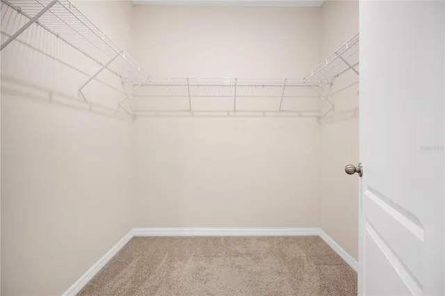 a view of hallway with windows and cabinet