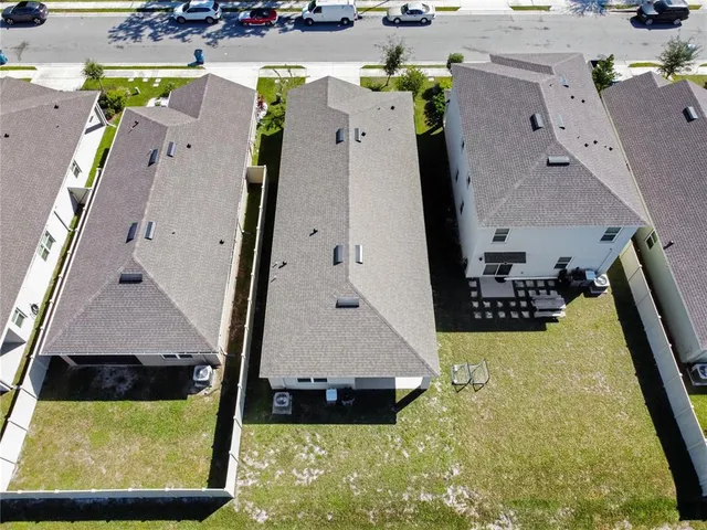 an aerial view of a house with a swimming pool