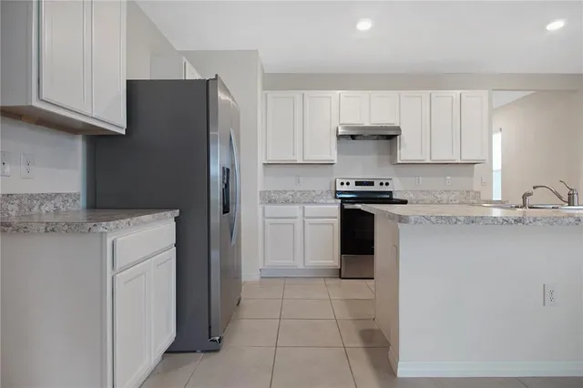 a kitchen with cabinets and stainless steel appliances