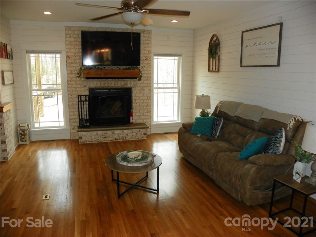 10617 Fink Road Mount Pleasant, NC 28124 - Photo 12 of 45 a living room with furniture and a wooden floor