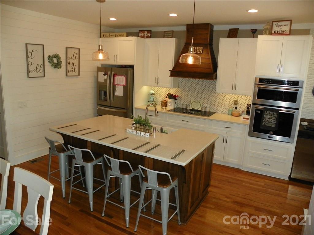 10617 Fink Road Mount Pleasant, NC 28124 - Photo 14 of 45 a kitchen with a sink cabinets and wooden floor