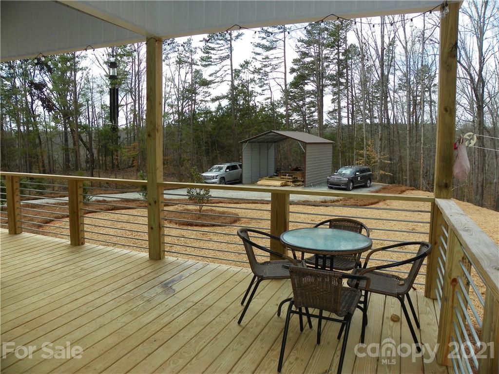 10617 Fink Road Mount Pleasant, NC 28124 - Photo 19 of 45 a view of a patio with table and chairs with wooden floor and fence