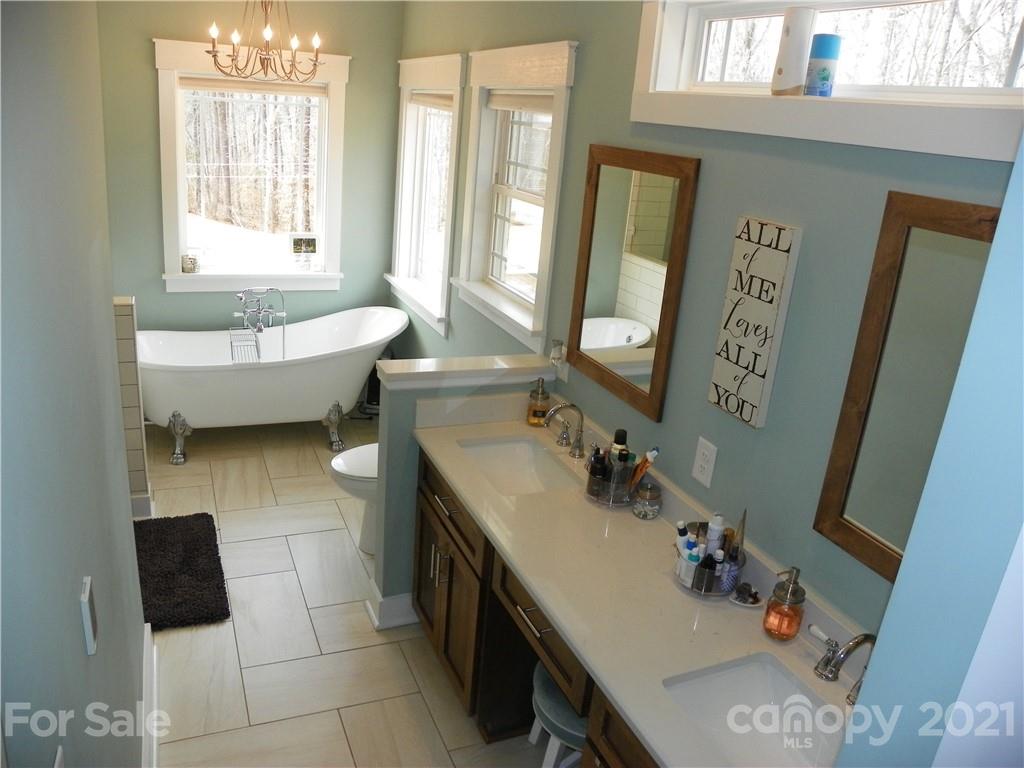 10617 Fink Road Mount Pleasant, NC 28124 - Photo 24 of 45 a bathroom with a sink mirror and tub