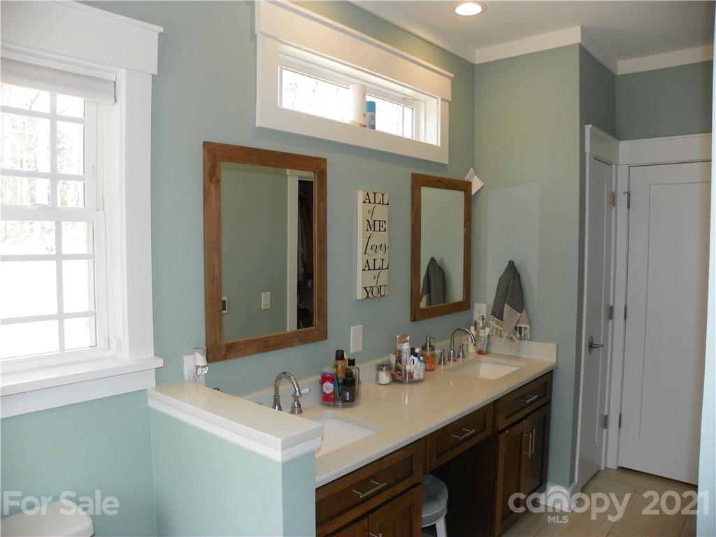 10617 Fink Road Mount Pleasant, NC 28124 - Photo 25 of 45 a bathroom with a sink vanity and a mirror