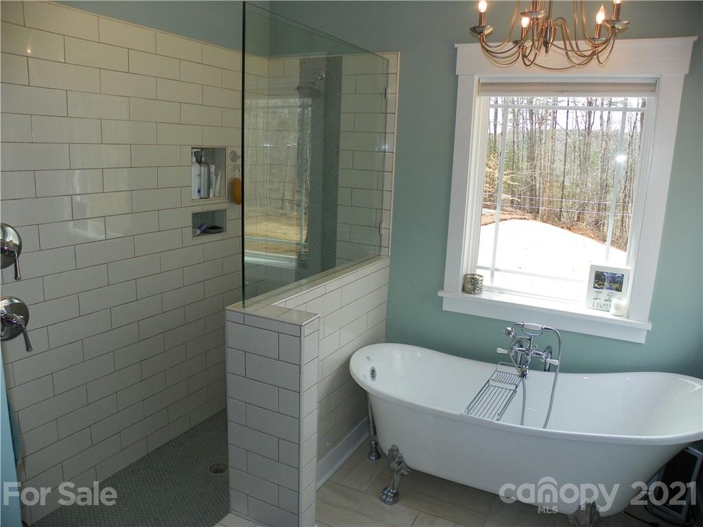 10617 Fink Road Mount Pleasant, NC 28124 - Photo 27 of 45 a bathroom with a tub a sink and window