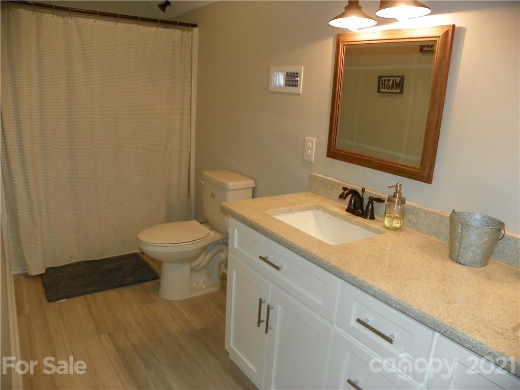 10617 Fink Road Mount Pleasant, NC 28124 - Photo 37 of 45 a bathroom with a granite countertop sink and a mirror