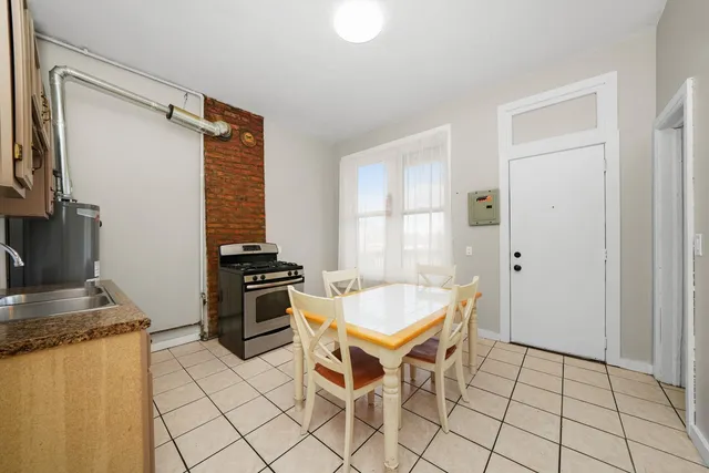 a kitchen with a table chairs and a refrigerator