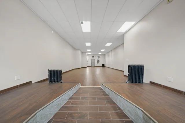 a view of a room with wooden floor and window