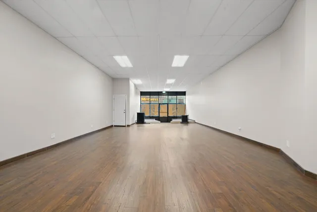 a view of empty room with a window and couch