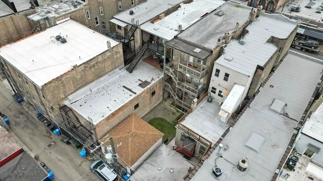 an aerial view of a residential apartment building with parking space