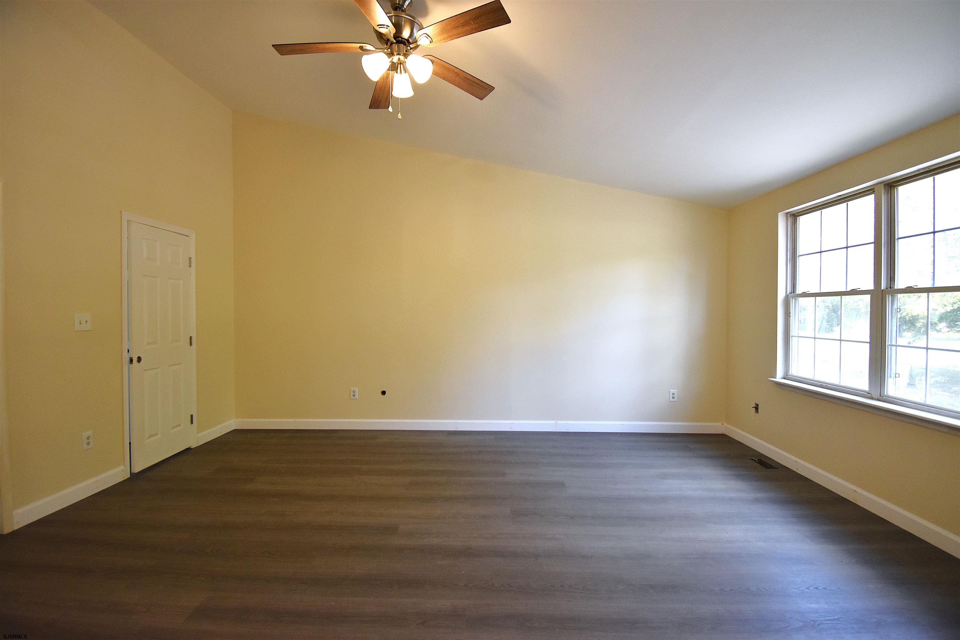 3580 South Main Road Vineland, NJ 08360 - Photo 3 of 11 a view of an empty room with wooden floor and a window