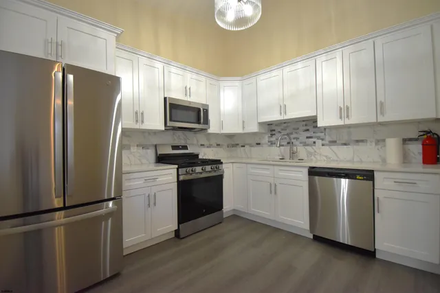 a kitchen with a refrigerator stove and microwave