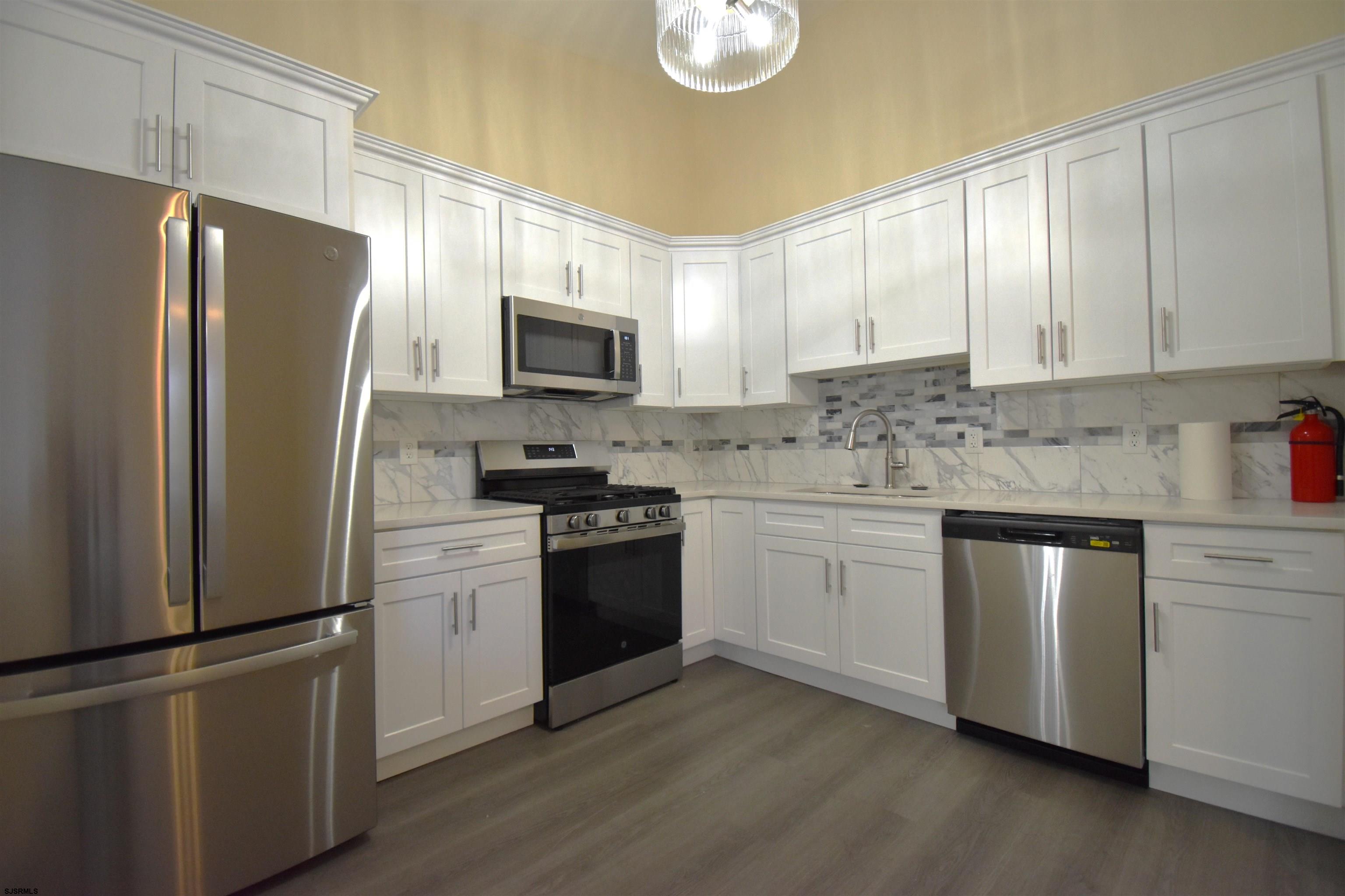 3580 South Main Road Vineland, NJ 08360 - Photo 5 of 11 a kitchen with a refrigerator stove and microwave