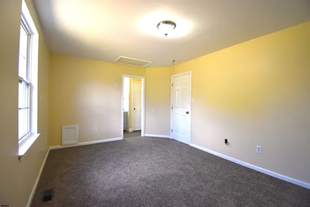 a view of an empty room and a window