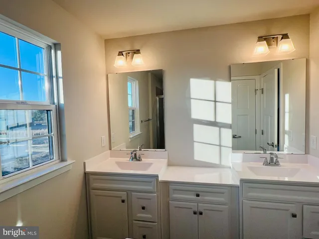 a bathroom with a double vanity sink mirror and double