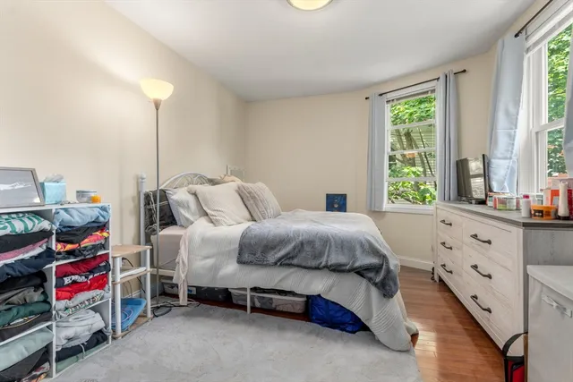 a spacious bedroom with a bed and a window