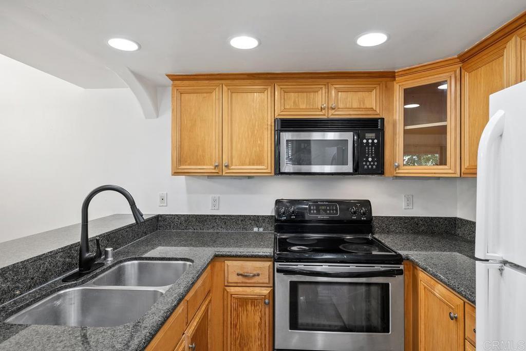 1145 Helix Street, Unit 1 Spring Valley, CA 91977 - Photo 11 of 30 a kitchen with granite countertop a stove and a sink