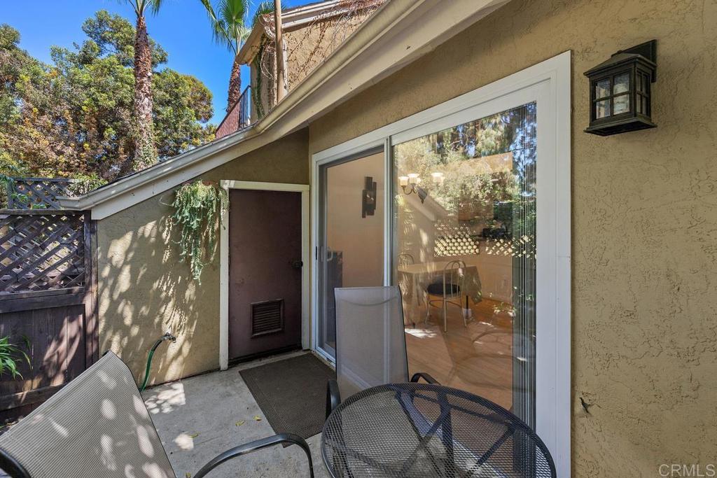 1145 Helix Street, Unit 1 Spring Valley, CA 91977 - Photo 17 of 30 a balcony with table and chairs and potted plants