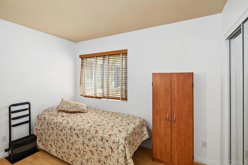 1145 Helix Street, Unit 1 Spring Valley, CA 91977 - Photo 22 of 30 a bedroom with a bed and a window
