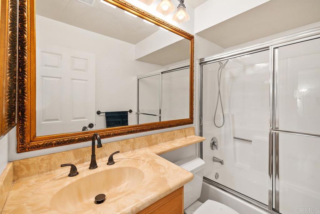 1145 Helix Street, Unit 1 Spring Valley, CA 91977 - Photo 24 of 30 a bathroom with a sink and a large mirror