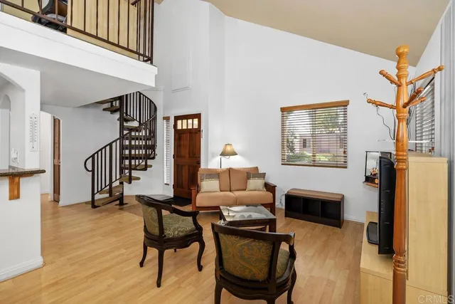 a dining room with furniture a fireplace and wooden floor