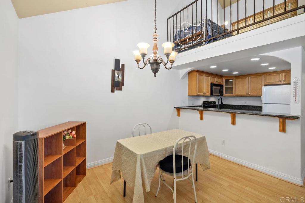 1145 Helix Street, Unit 1 Spring Valley, CA 91977 - Photo 8 of 30 a view of kitchen with cabinets and wooden floor