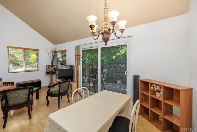 a view of a dining room with furniture wooden floor and chandelier