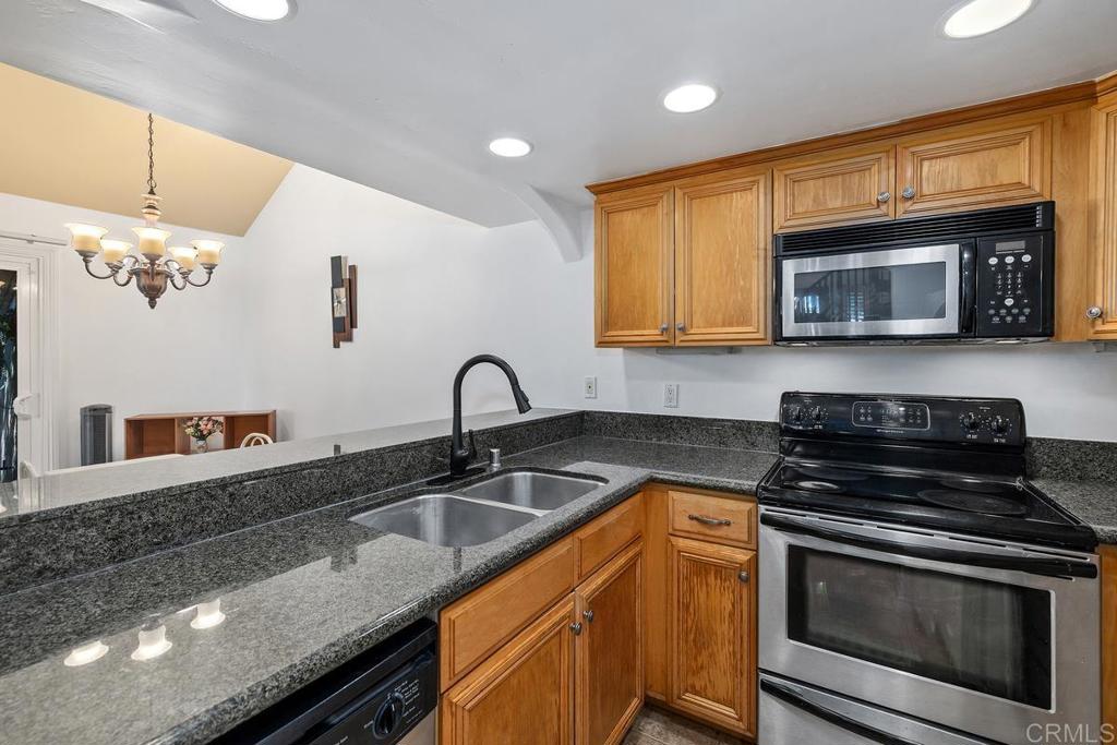1145 Helix Street, Unit 1 Spring Valley, CA 91977 - Photo 10 of 30 a kitchen with stainless steel appliances granite countertop a stove a sink and a microwave
