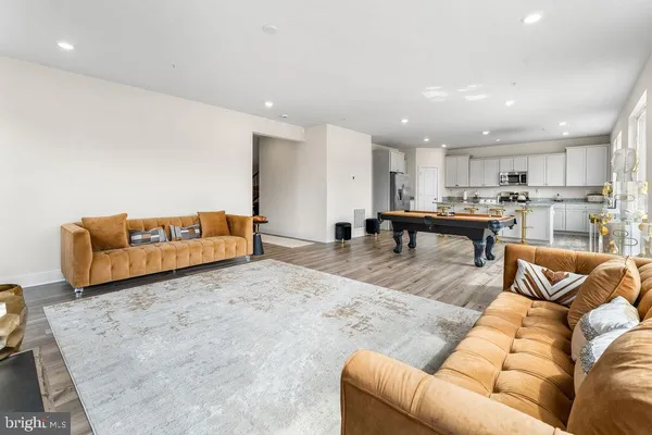 a living room with furniture and kitchen view
