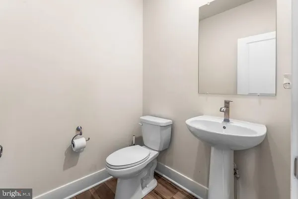 a bathroom with a sink a toilet and mirror