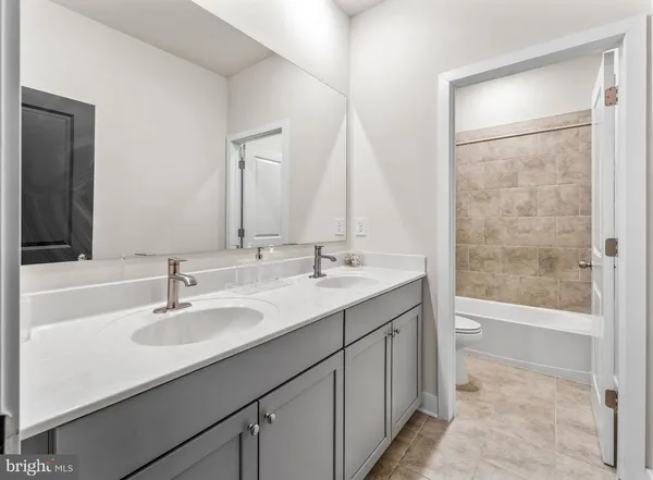 a bathroom with a sink double vanity and a mirror