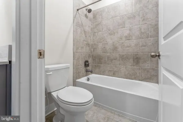 a bathroom with a toilet and a bath tub