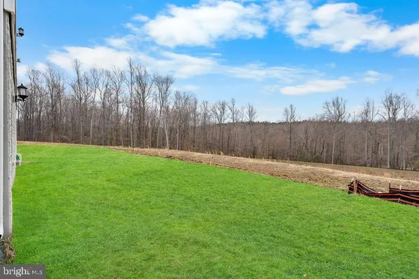 a view of a backyard with furniture and wooden fence
