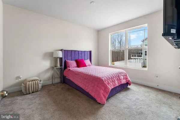 a bedroom with a bed and a tv on table