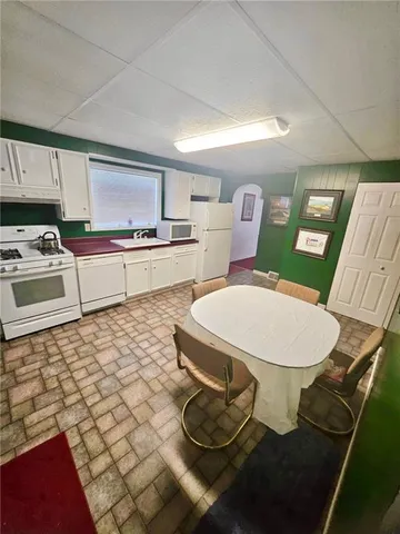a kitchen with a sink appliances and cabinets